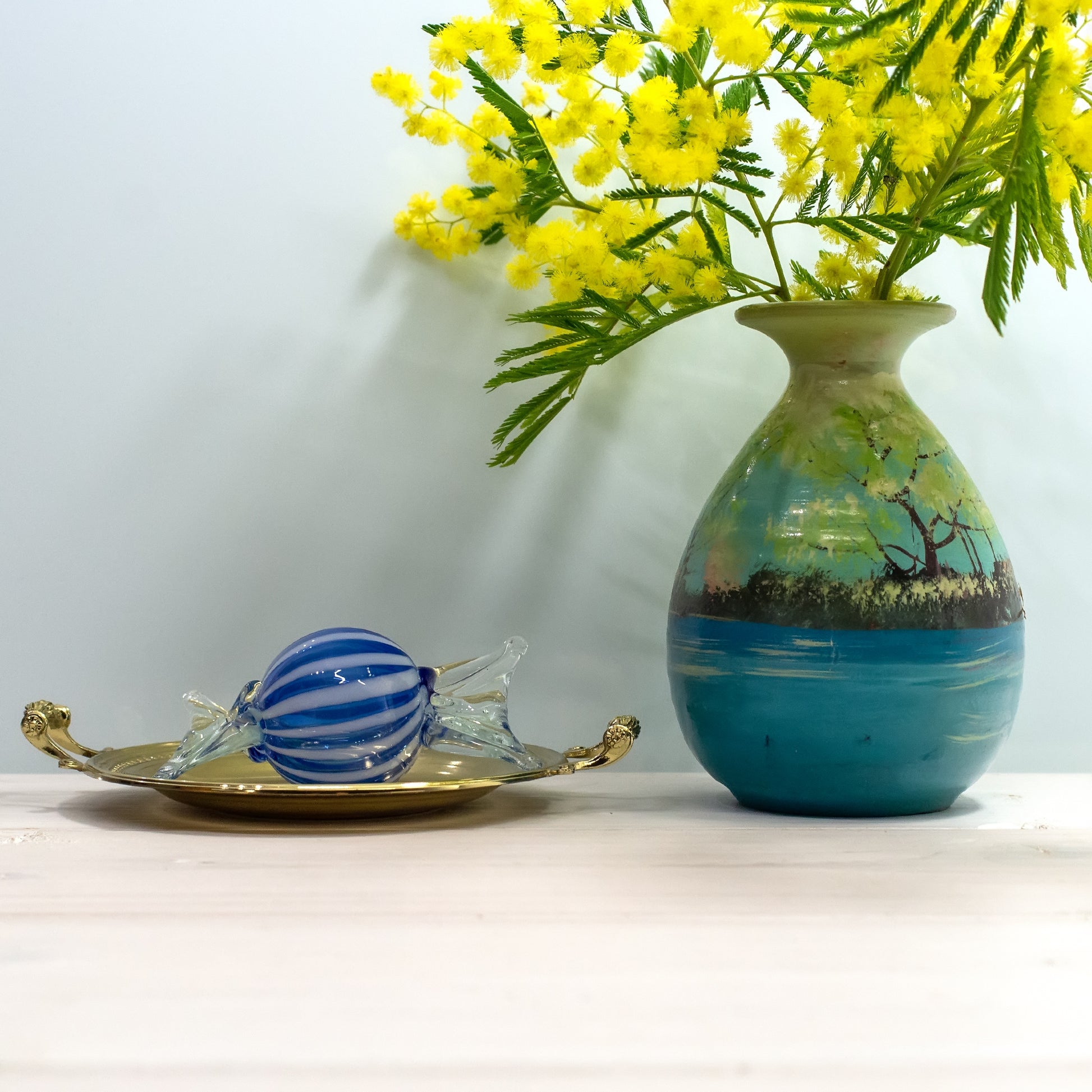 Blue and white striped Murano glass candy on plate