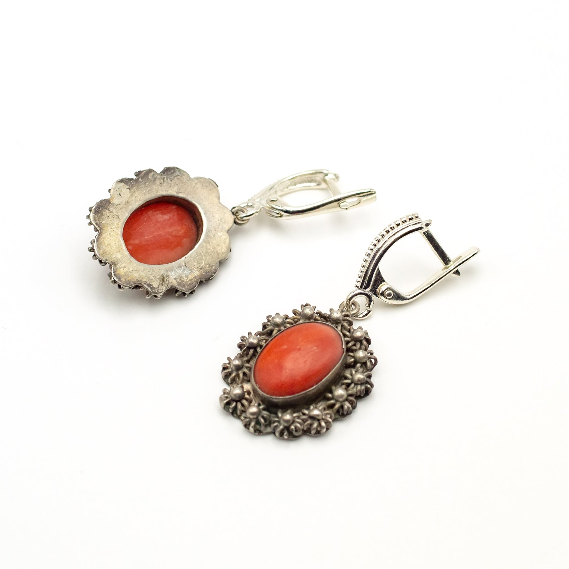 earrings large oval scarlet coral in a blackened silver frame in the shape of a wreath of small flowers