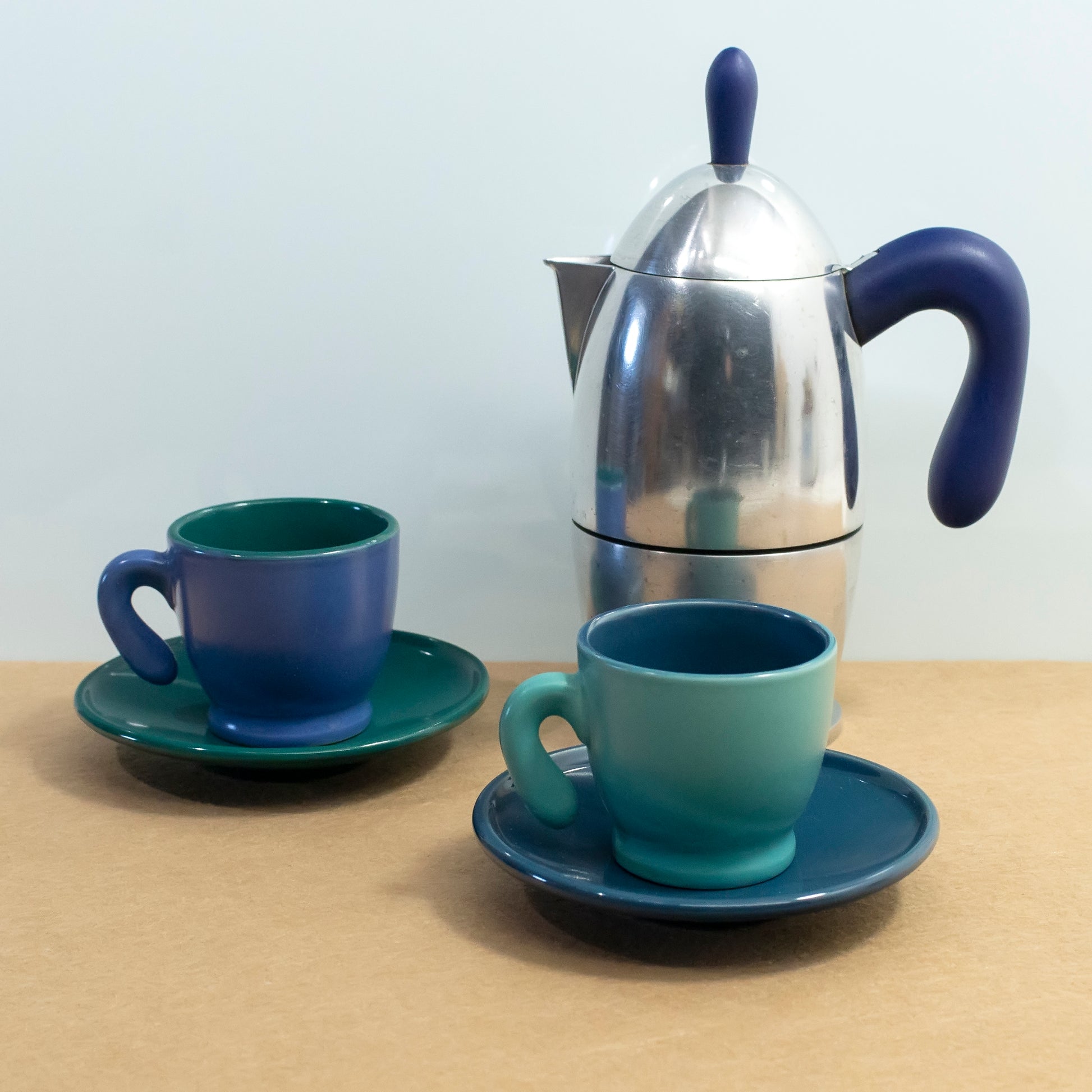 Coffee maker with two blue-green cups