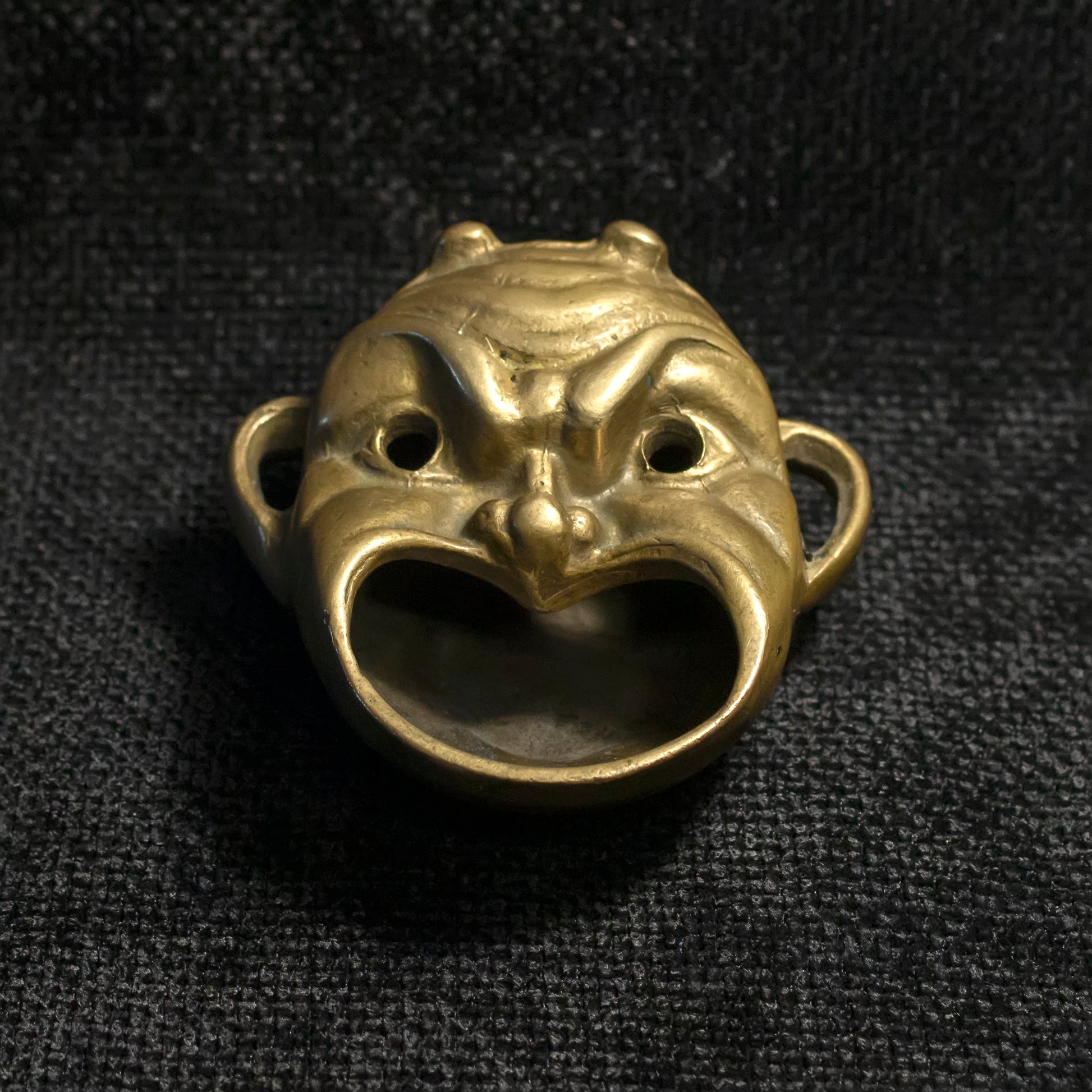 Mask shaped brass ashtray