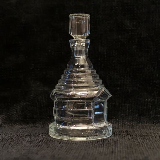 clear glass decanter shaped like a traditional Italian trullo building