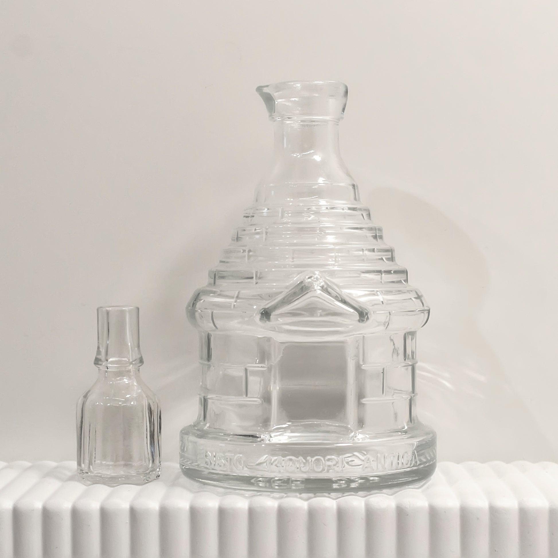 small glass decanter shaped like a traditional Italian trullo building